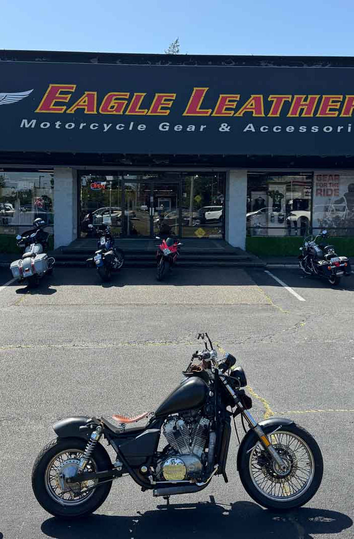Motorcycles parked outside Eagle Leather’s Lakewood store under sunny skies