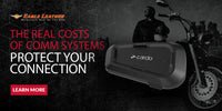 Eagle Leather banner featuring 'The Real Costs of Comm Systems – Protect Your Connection.' Cardo communication device in foreground, male biker and cruiser motorcycle in the background. Learn More button. Eagle Leather logo top left.