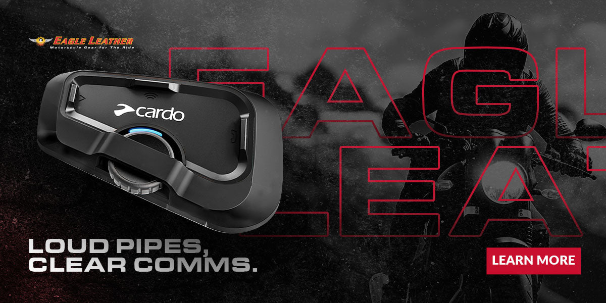 Eagle Leather banner with Cardo motorcycle communication device, tagline 'Loud Pipes, Clear Comms.' in bold, background silhouette of rider on motorcycle, Eagle Leather logo, and red Learn More button.