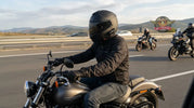 Motorcycle rider using a helmet communication system at highway speeds