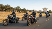 Group of cruiser motorcycles riding on an open highway demonstrating real rider-to-rider communication range