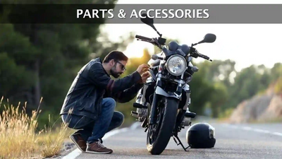 Motorcycle Parts and Accessories Collection. A man fixing a motorcycle on the road. Eagle Leather
