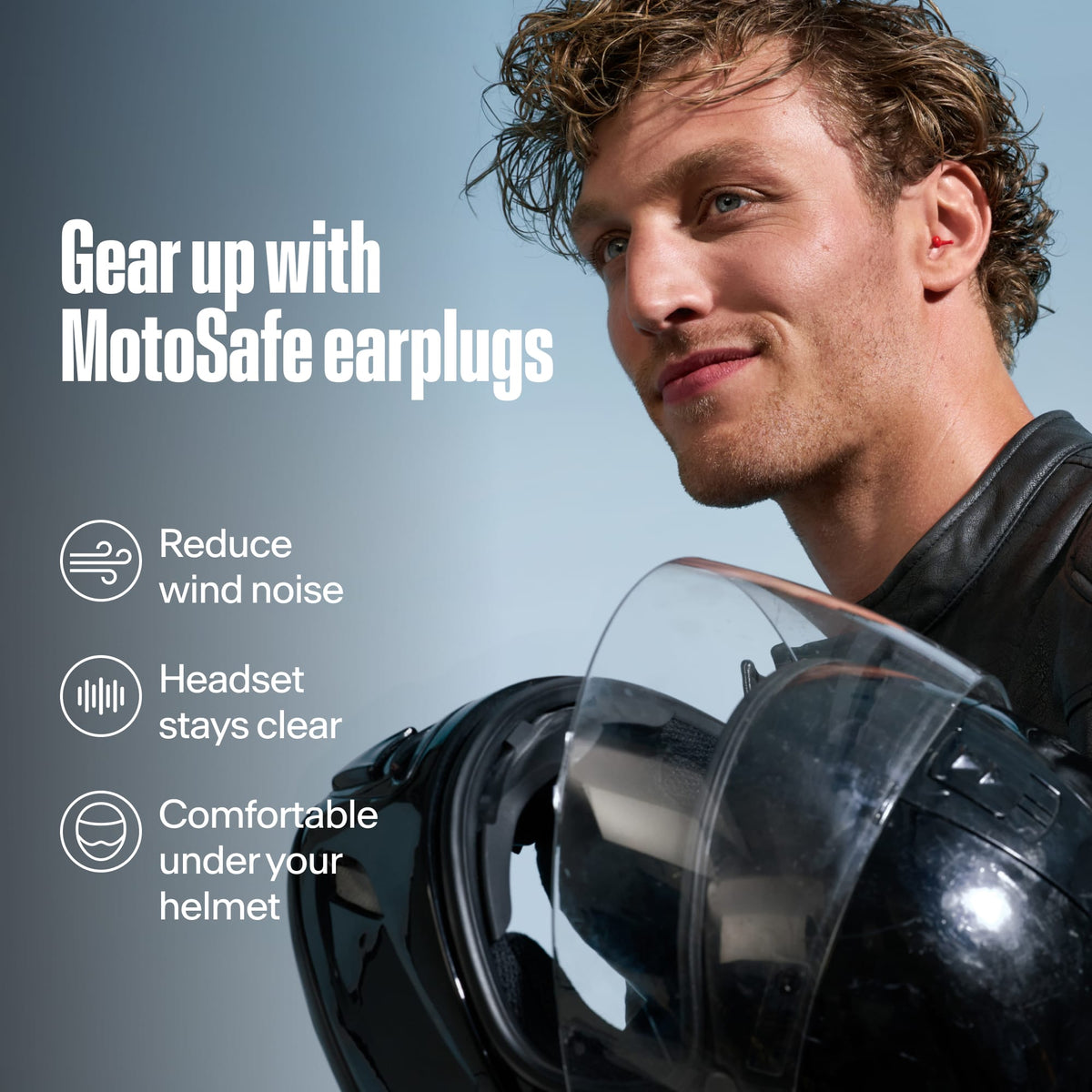 Motorcyclist holding a helmet with Alpine MotoSafe Sport earplugs