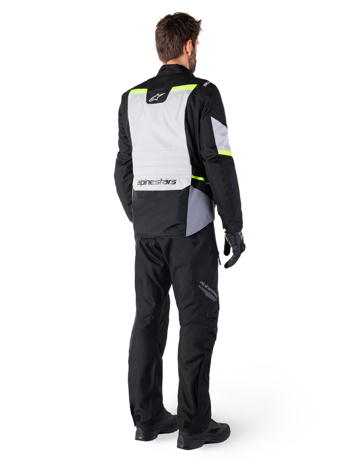 Alpinestars ST-1 Waterproof Pants, Black, rear three-quarter view styled with riding gear