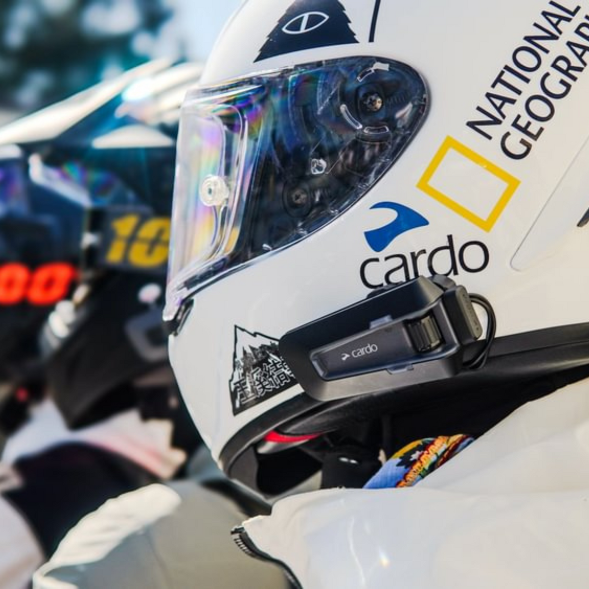 Cardo PACKTALK NEO black communicator mounted on a rider's full-face helmet