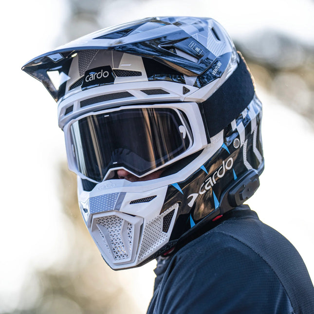 Rider wearing the Cardo VENTURE off-road helmet with goggles