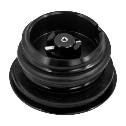 Underside of black pop up Harley gas cap
