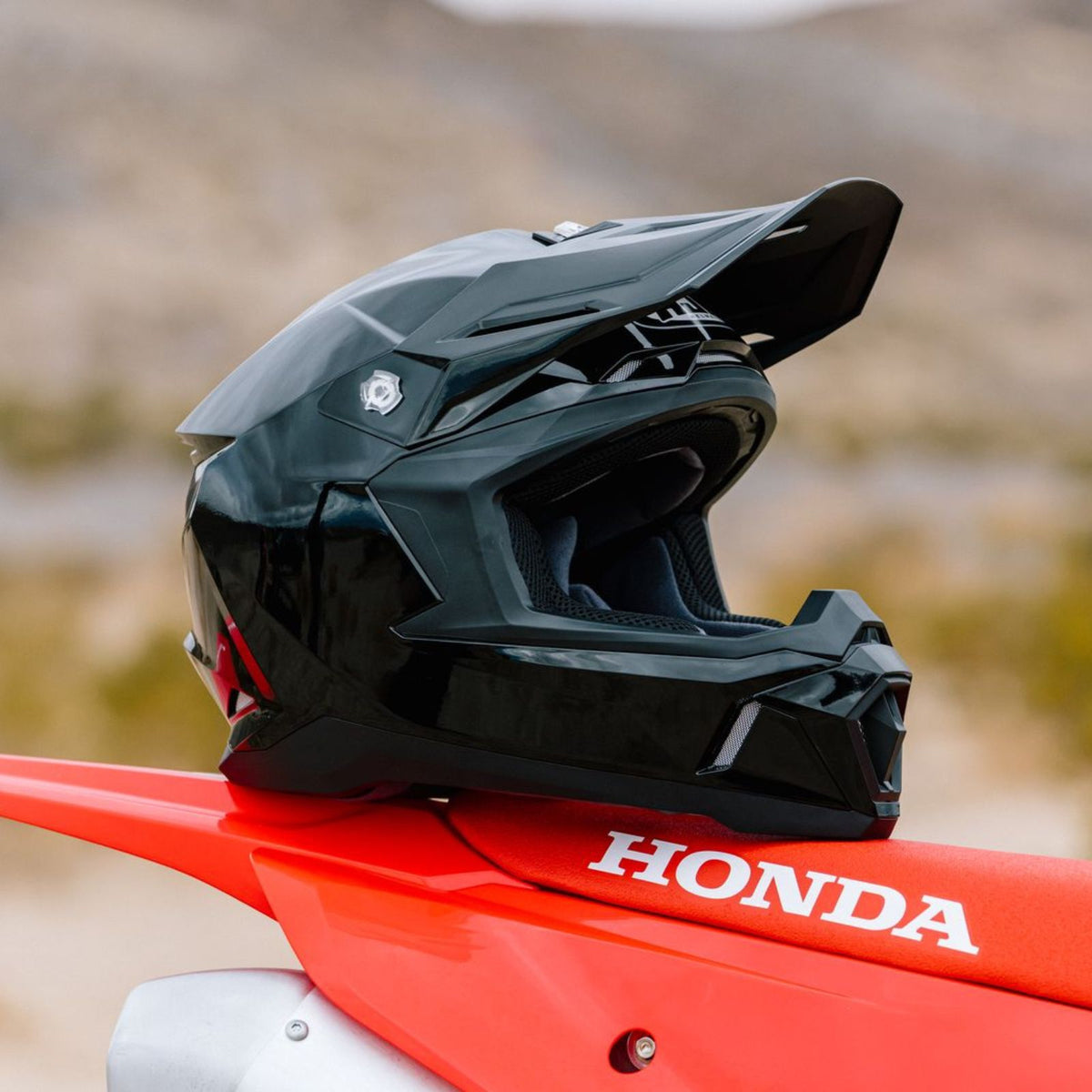 HJC C50 Matte Black helmet resting on a motocross bike