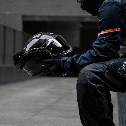 Rider holding the HJC F100 Carbon helmet