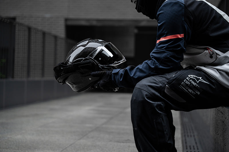 Rider holding the HJC F100 Carbon helmet