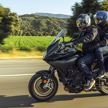 HJC F100 Solid helmets worn by rider and passenger on a touring motorcycle