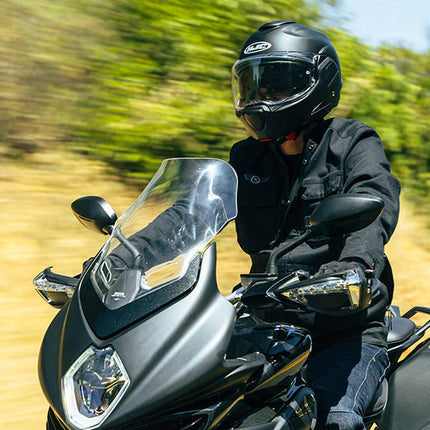 HJC F100 Solid helmet on a rider, front three-quarter riding view