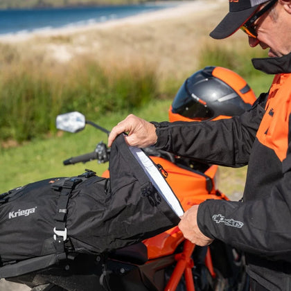 Rider accessing the removable waterproof liner of a Kriega US 20 Drypack