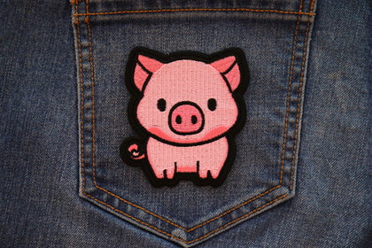 Little Piggy embroidered patch displayed on denim