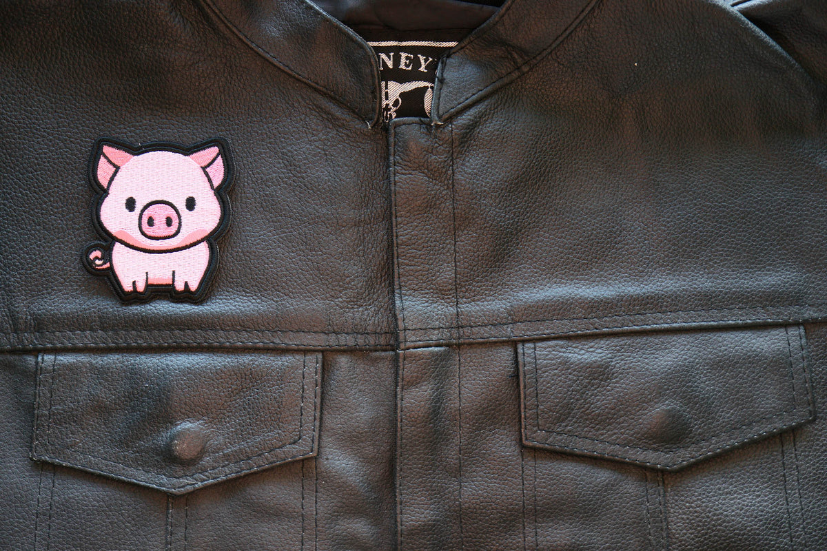 Little Piggy embroidered patch displayed on a motorcycle vest