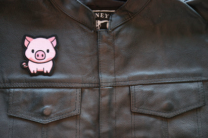 Little Piggy embroidered patch displayed on a motorcycle vest
