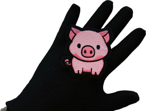 Little Piggy embroidered patch shown in hand for size reference