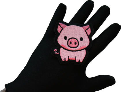 Little Piggy embroidered patch shown in hand for size reference