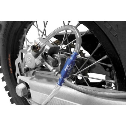 Motion Pro 08-0143 hydraulic brake bleeder connected to a motorcycle rear brake caliper