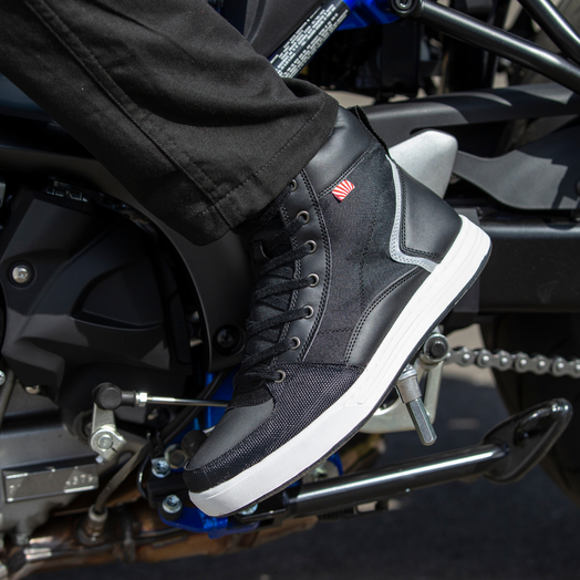 NORU Men’s Tori Boot in black positioned on a motorcycle footpeg