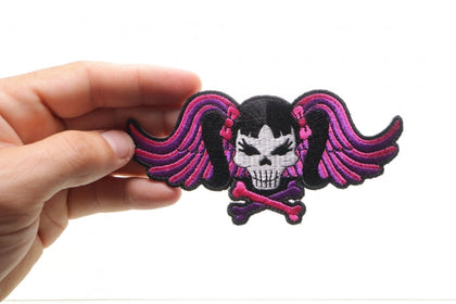 Pigtails Skull and Wings patch shown in hand for size reference