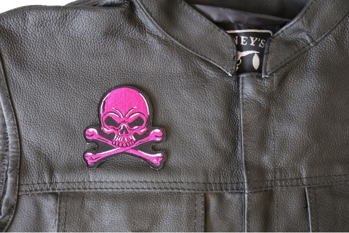 Pink Skull and Crossbones patch installed on a leather vest