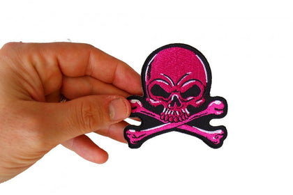 Pink Skull and Crossbones patch shown in hand for size reference