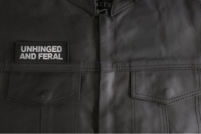 Unhinged and Feral patch installed on a leather vest