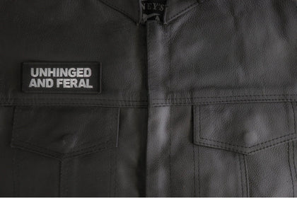 Unhinged and Feral patch installed on a leather vest