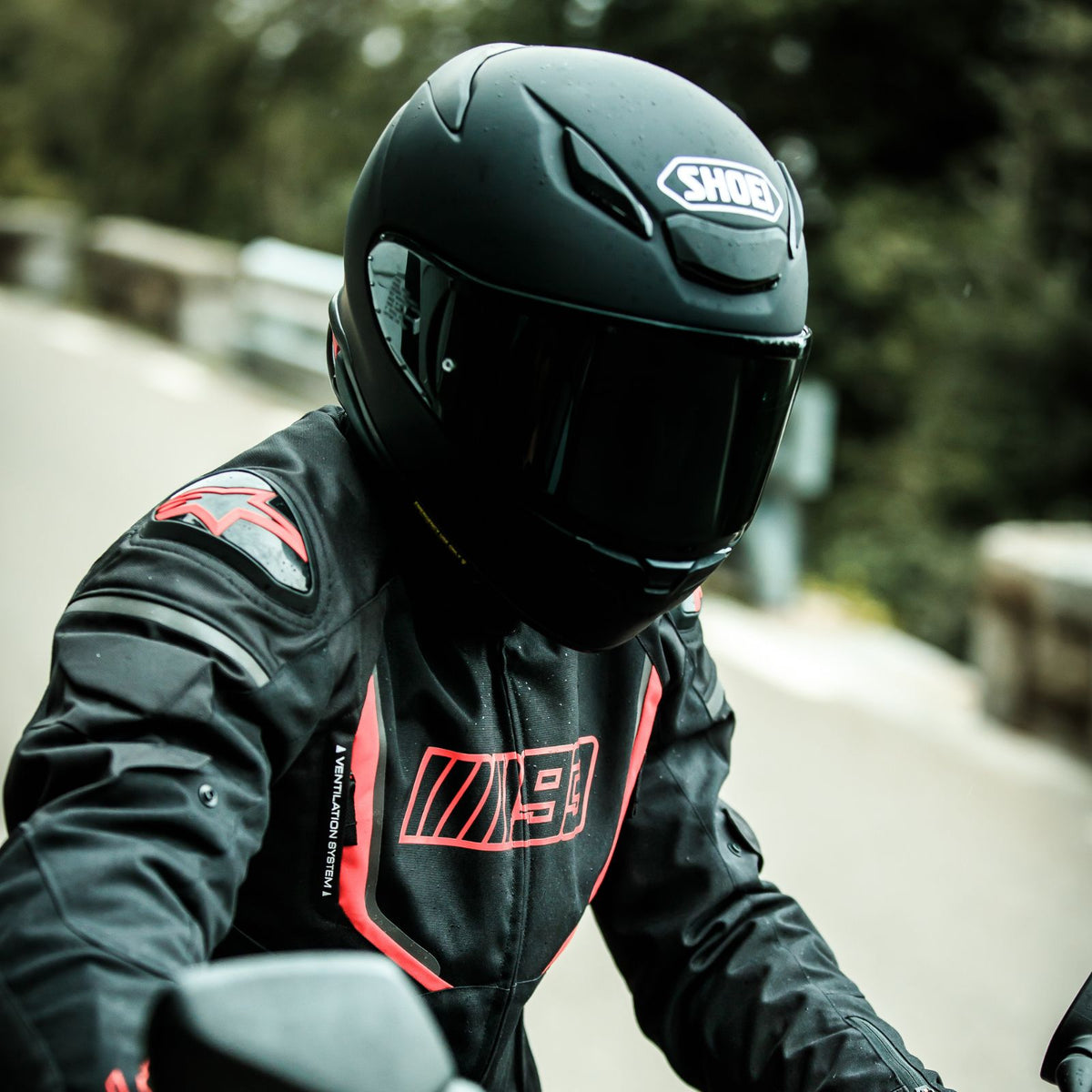 Shoei RF-1400 Solid Matte Black helmet worn by rider with optional tinted shield