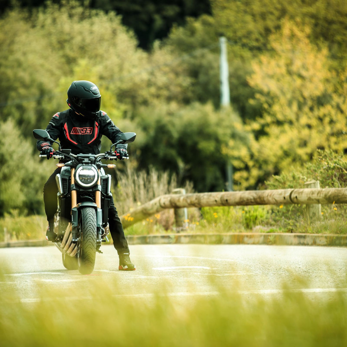 Shoei RF-1400 Solid Matte Black helmet on rider approaching on a road