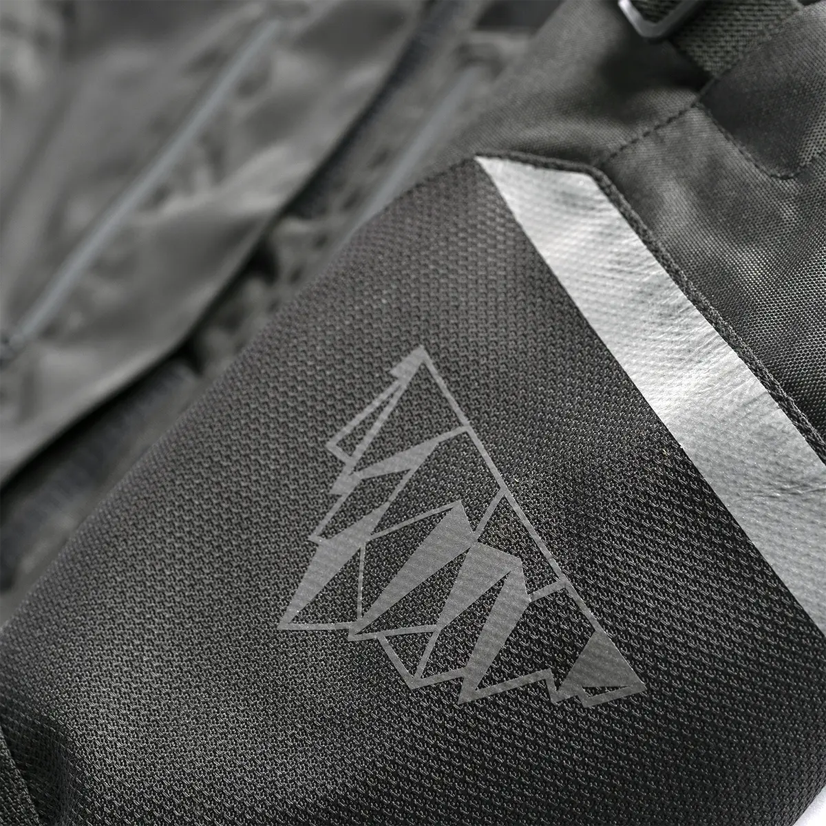 Tourmaster Centurion Lite black one-piece suit, reinforced impact-zone detail