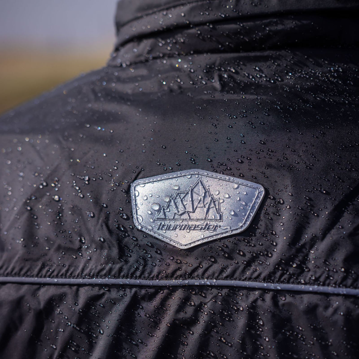 Tourmaster Defender Two-Piece Rainsuit in Black - rear collar detail with water droplets
