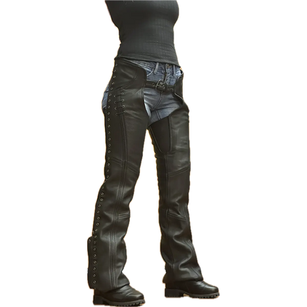 Women's black leather motorcycle chaps with lace-up sides, silver grommets, and adjustable front belt, worn over denim jeans and paired with black boots.