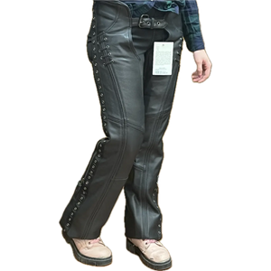 Woman wearing black leather lace-up motorcycle chaps over jeans, shown from a different angle to highlight the fit, detailing, and side lacing.