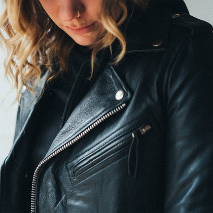 Women's Ryman black leather motorcycle jacket lapel and chest zipper detail