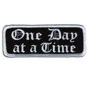 One Day At a Time Patch 4 Inch: Description
"One Day at a Time" embroidered in fancy white lettering on a black background wi